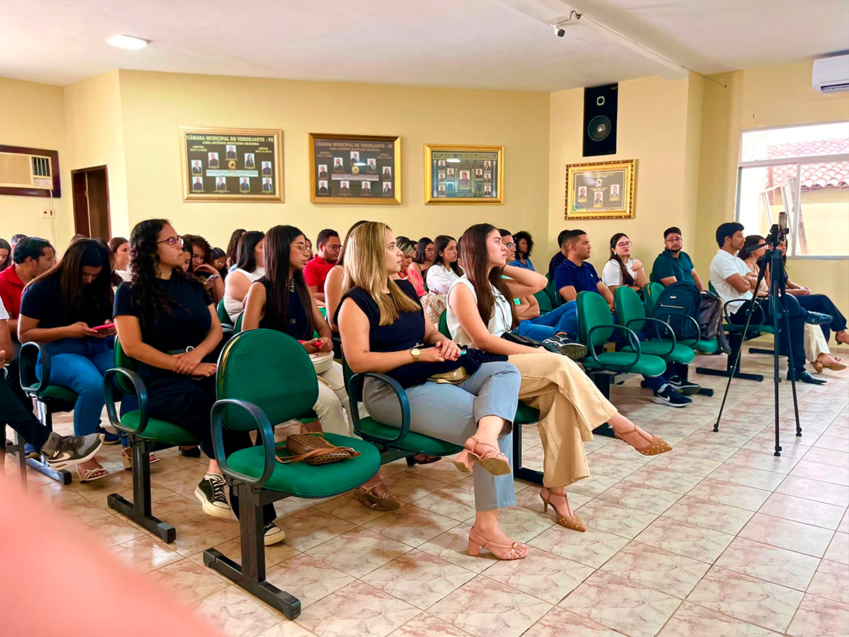 Auditório com pessoas assistindo as palestras